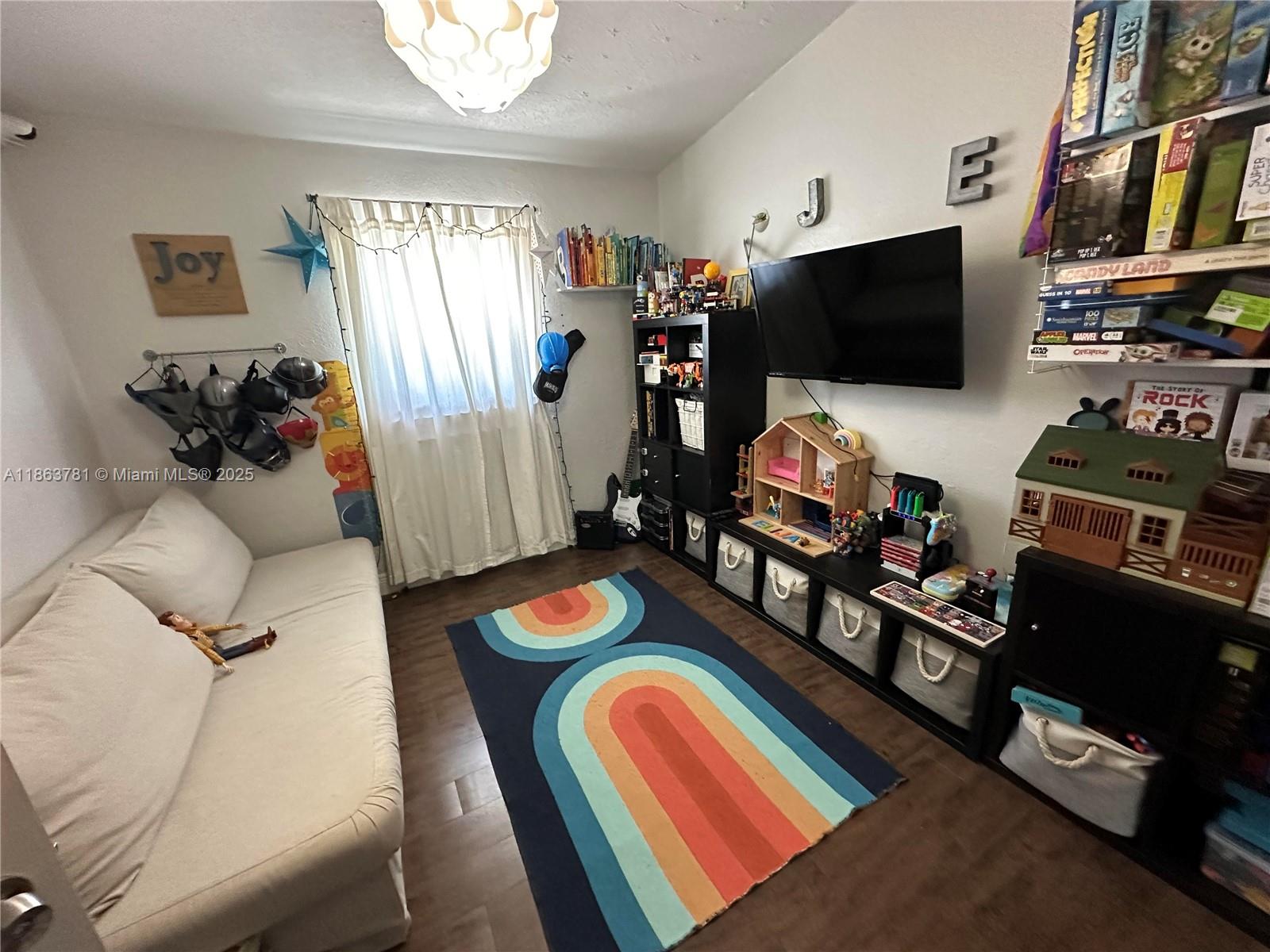 7310 Southwest 31st Street Miami, FL 33155 - Photo 14 of 25 a living room with furniture and a flat screen tv