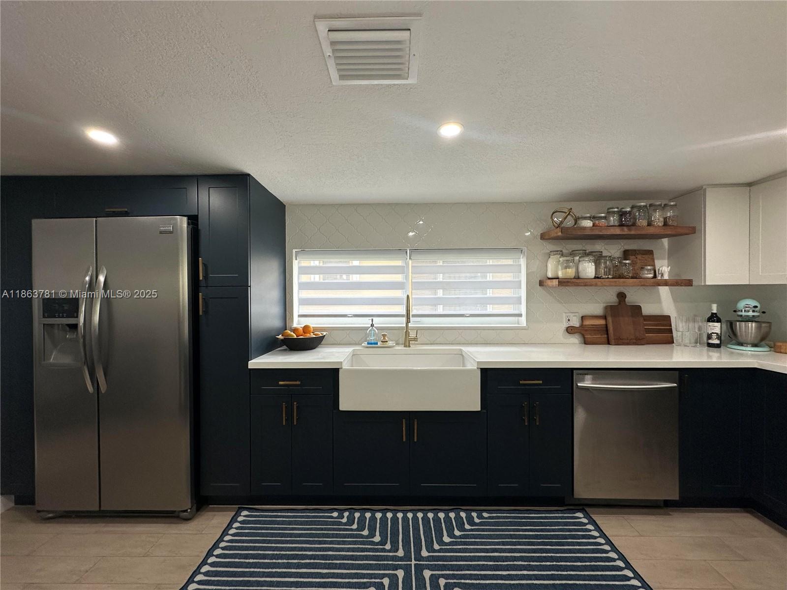 7310 Southwest 31st Street Miami, FL 33155 - Photo 3 of 25 a kitchen with a sink stainless steel appliances and cabinets