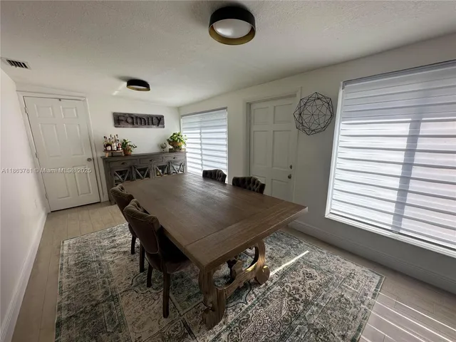 a dining room with furniture and window