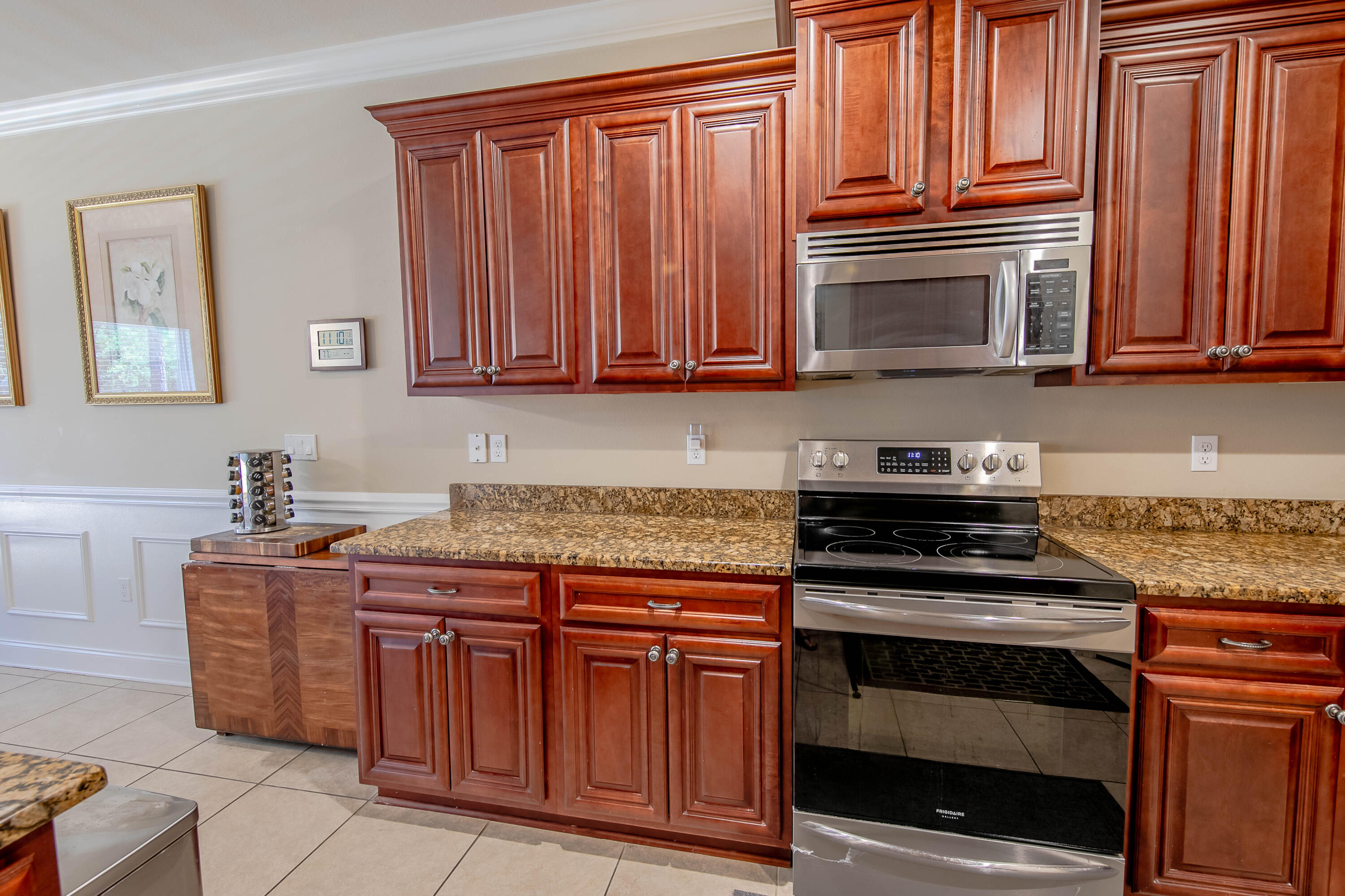 456 Windchime Way Freeport, FL 32439 - Photo 12 of 34 a kitchen with granite countertop wooden cabinets and stainless steel appliances