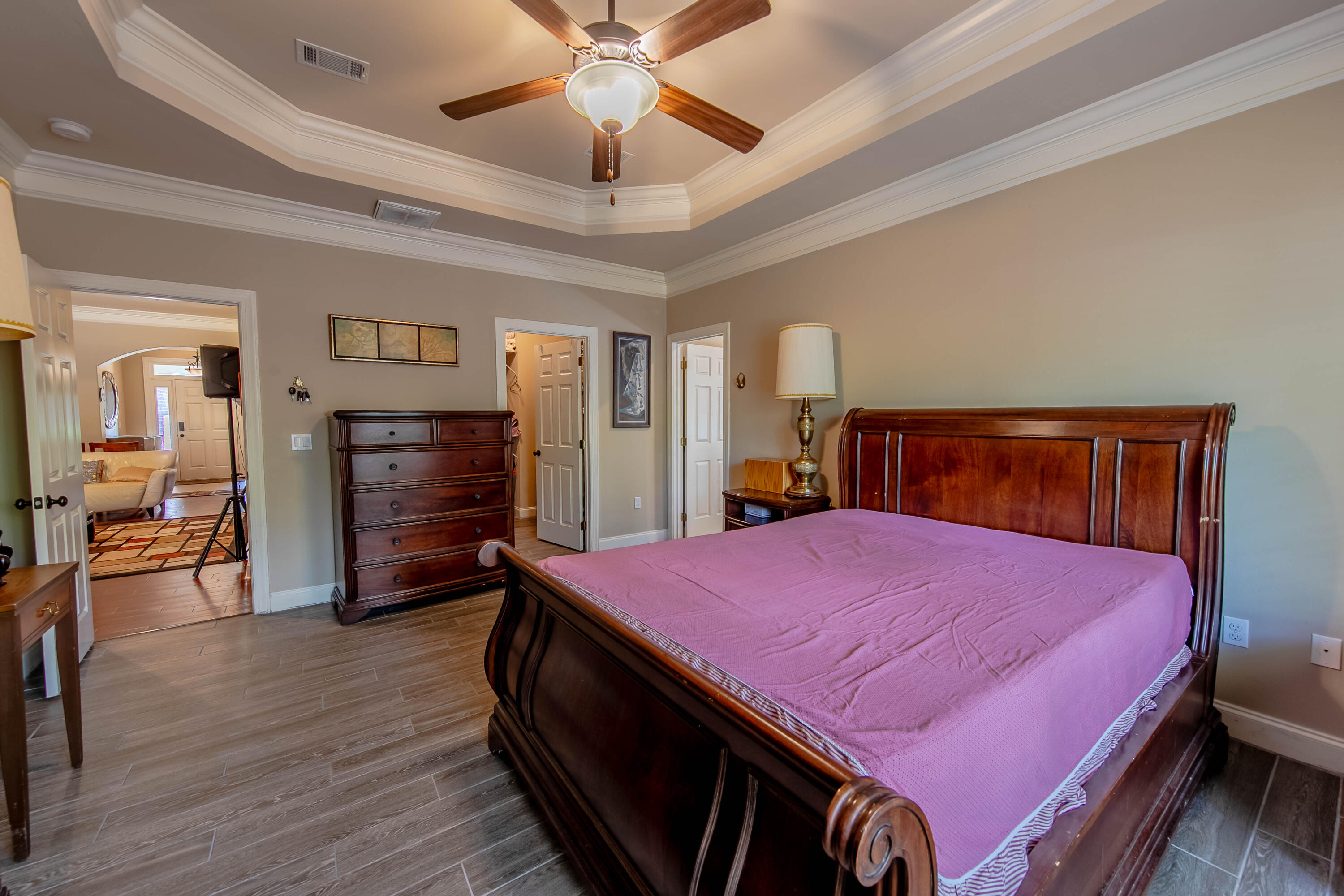 456 Windchime Way Freeport, FL 32439 - Photo 17 of 34 a bedroom with a bed and a chandelier