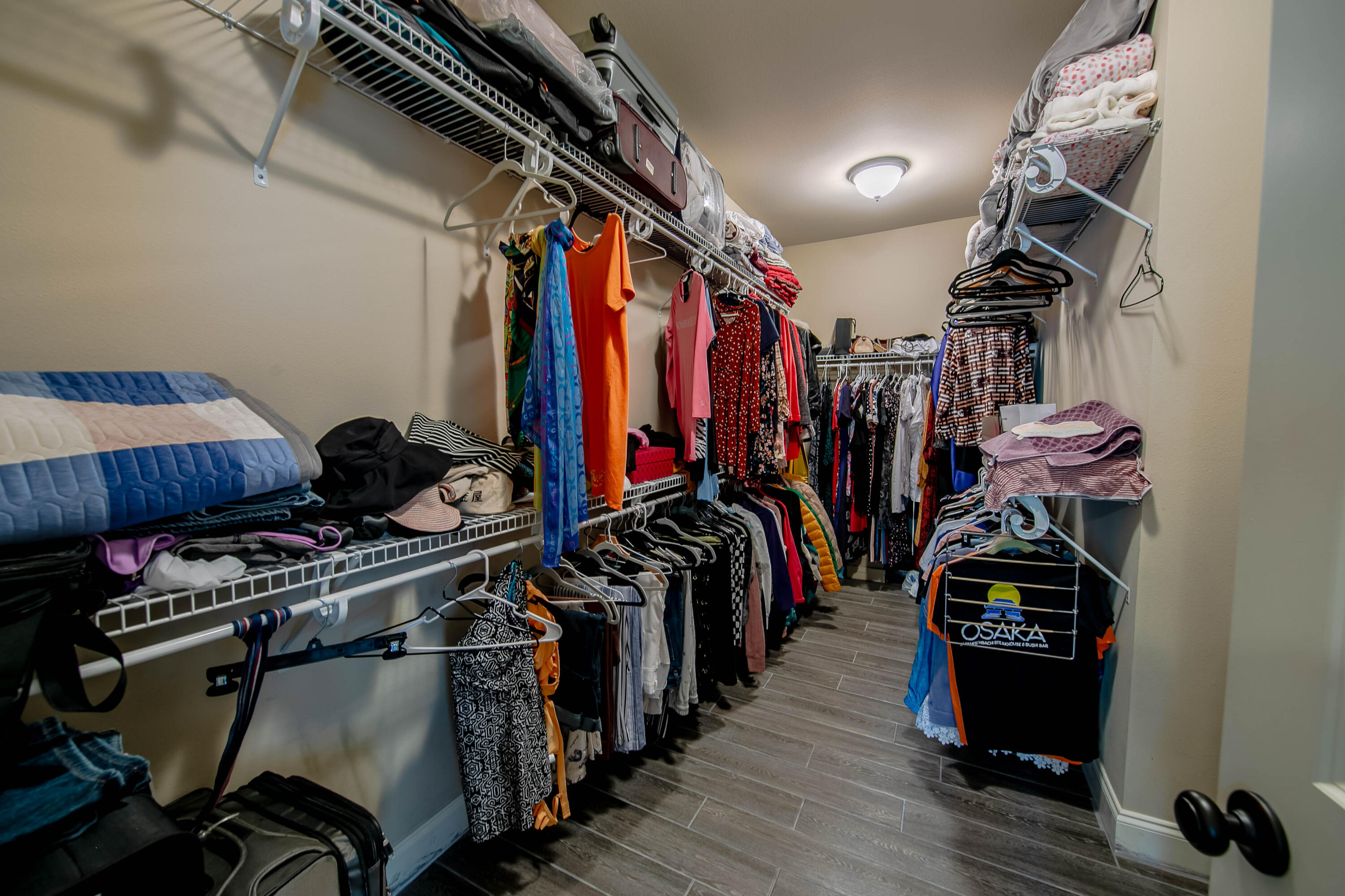 456 Windchime Way Freeport, FL 32439 - Photo 19 of 34 a view of walk in closet with clothes and shoes