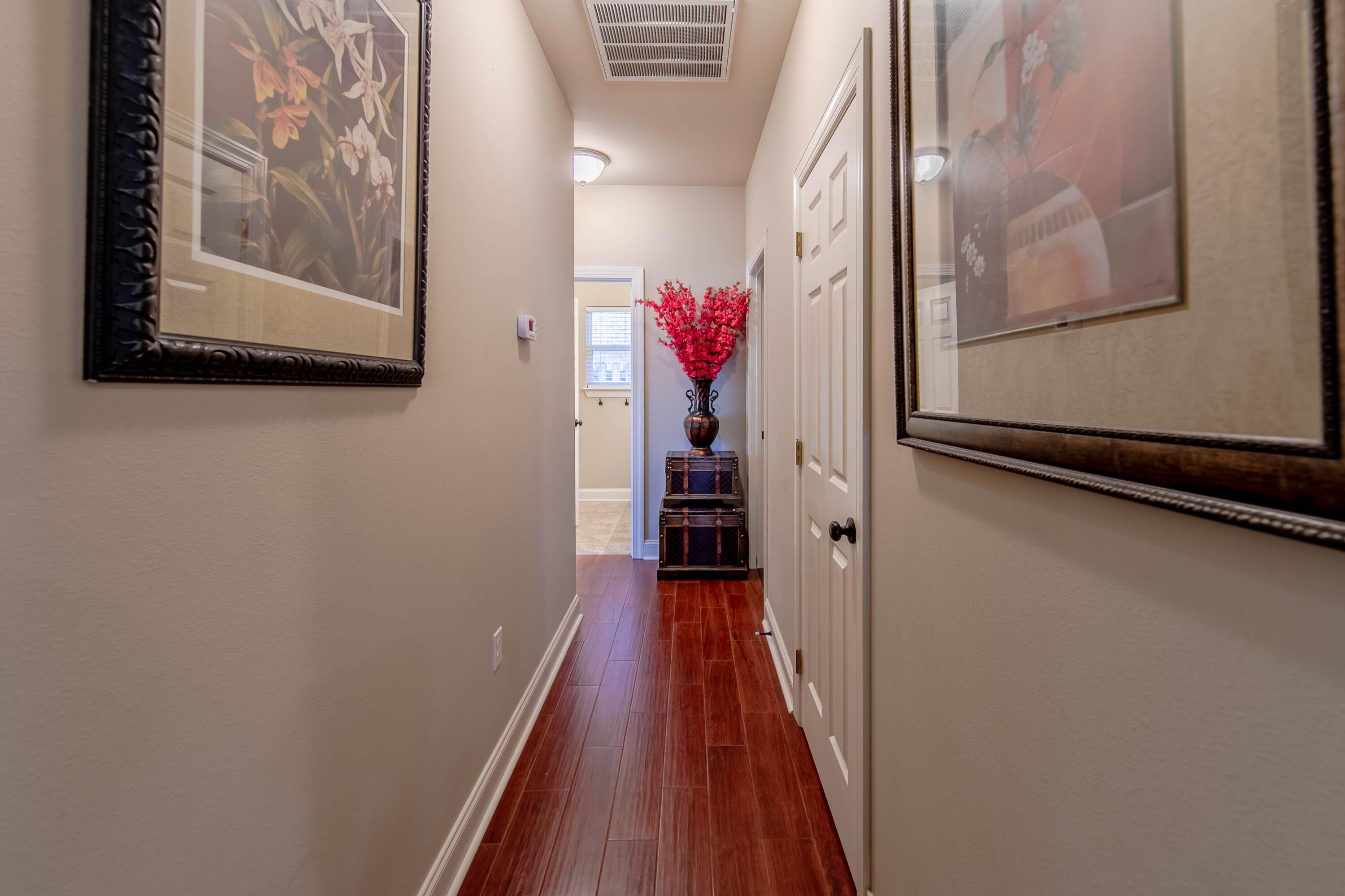 456 Windchime Way Freeport, FL 32439 - Photo 23 of 34 a view of a hallway with wooden floor and closet