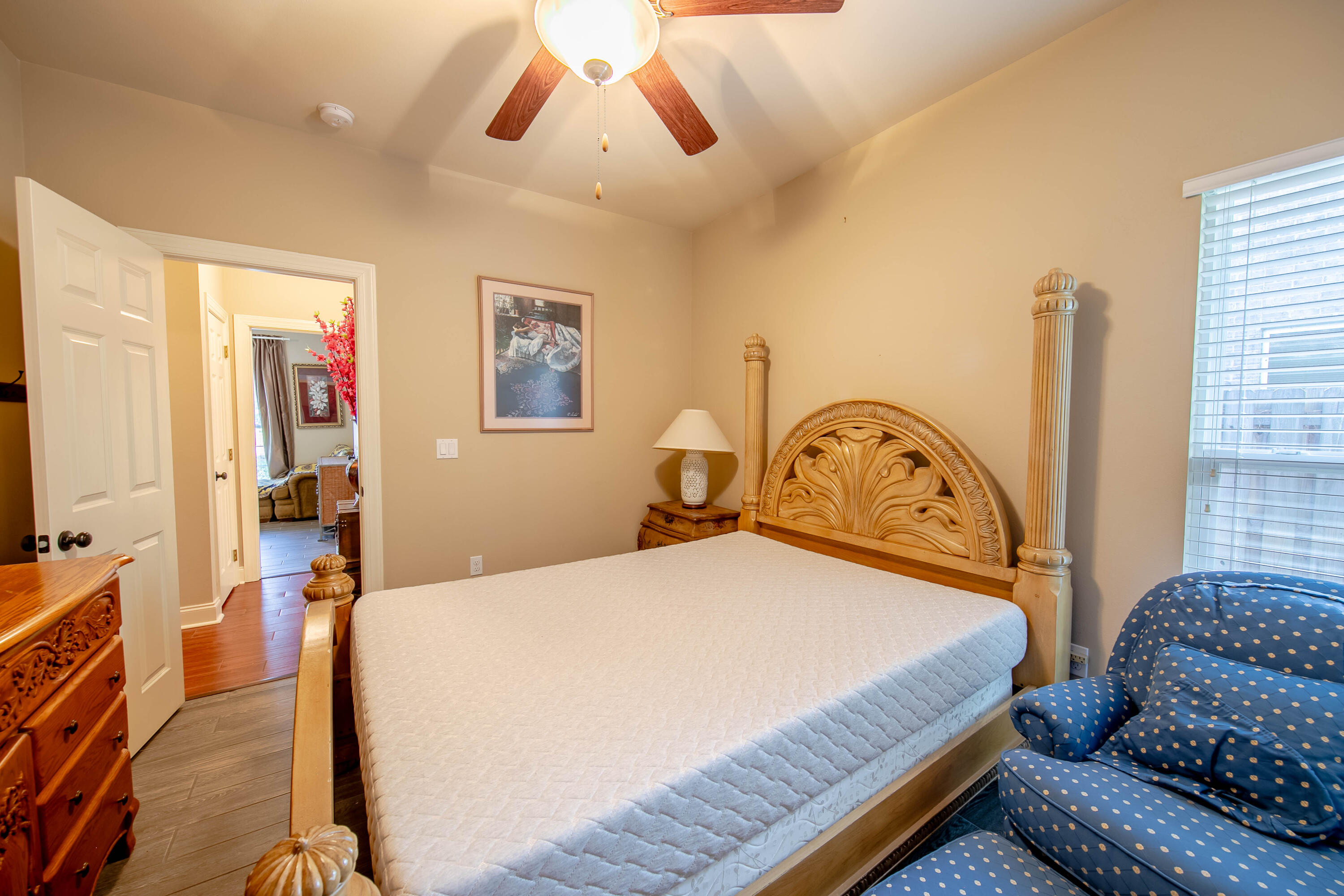 456 Windchime Way Freeport, FL 32439 - Photo 26 of 34 a bedroom with a bed dresser and a flat tv screen