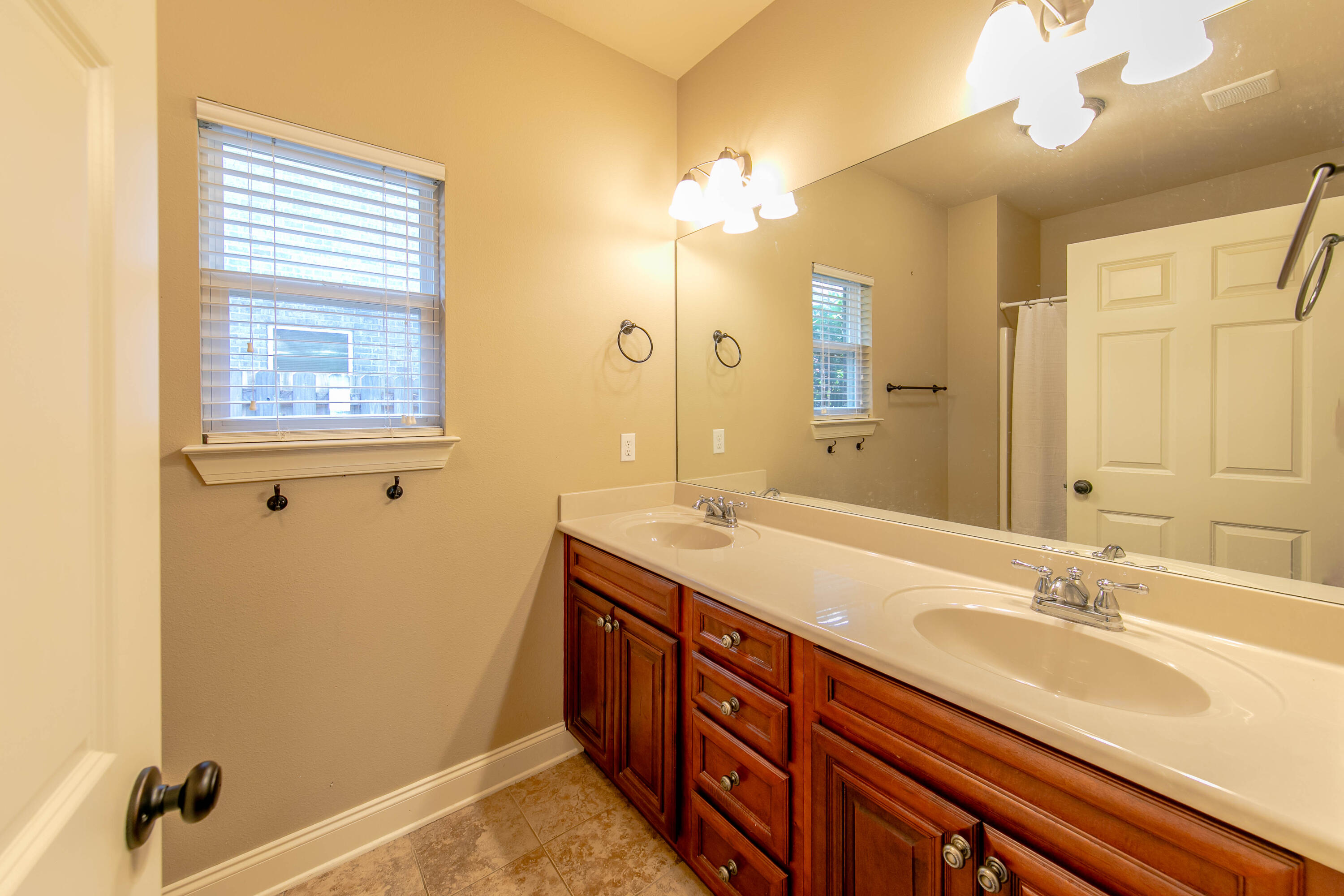 456 Windchime Way Freeport, FL 32439 - Photo 27 of 34 a bathroom with a double vanity sink and a mirror
