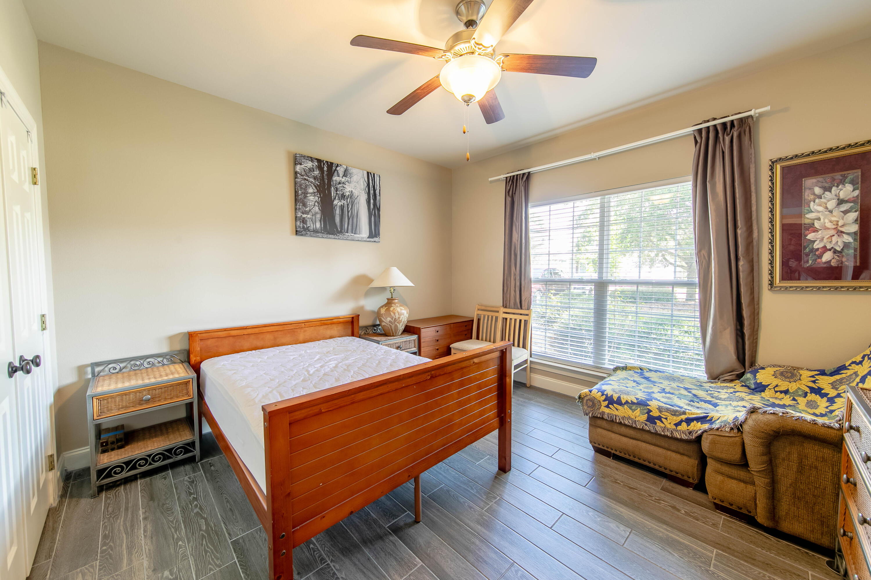 456 Windchime Way Freeport, FL 32439 - Photo 29 of 34 a bedroom with a bed and wooden floor