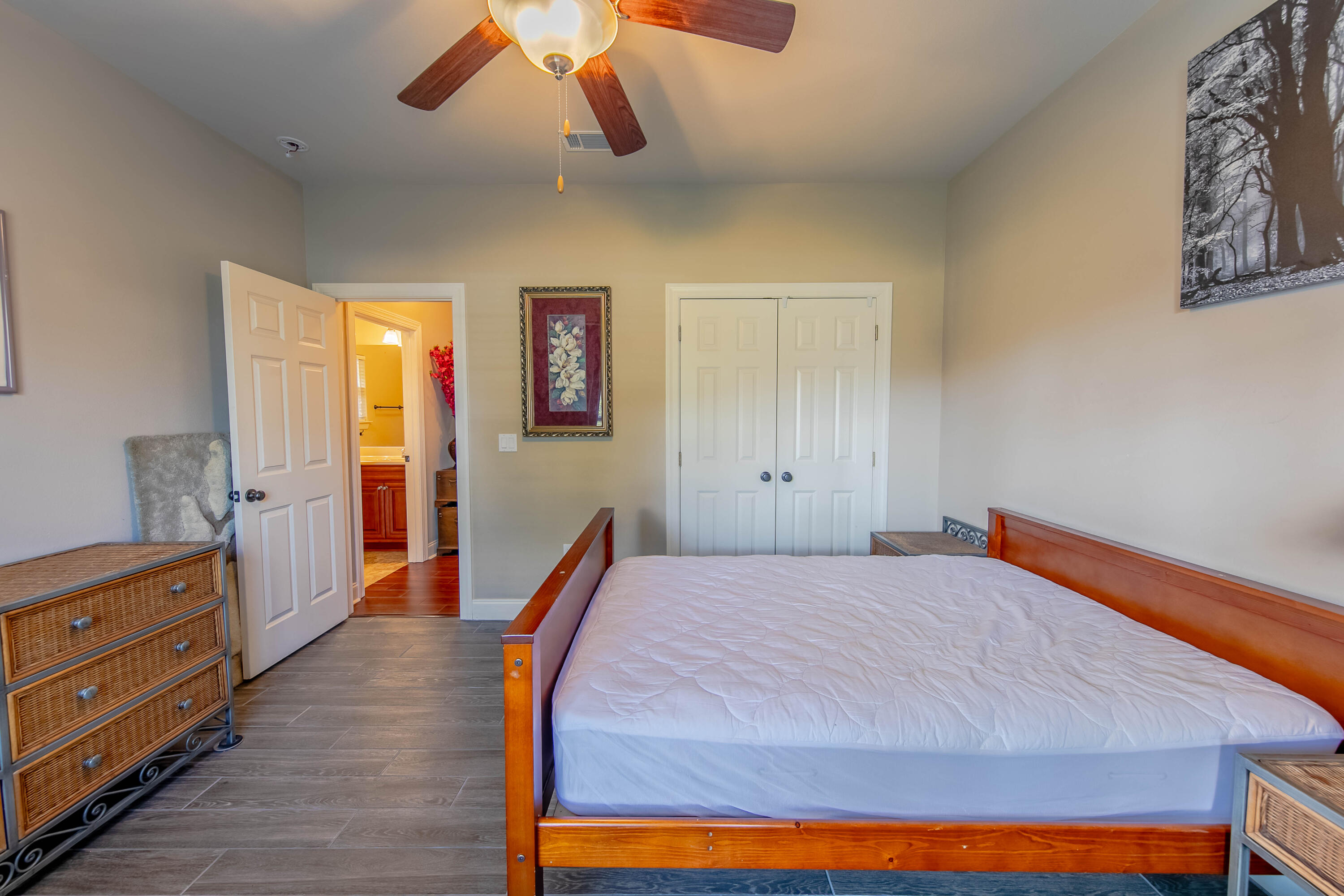456 Windchime Way Freeport, FL 32439 - Photo 30 of 34 a bedroom with a bed and wooden floor