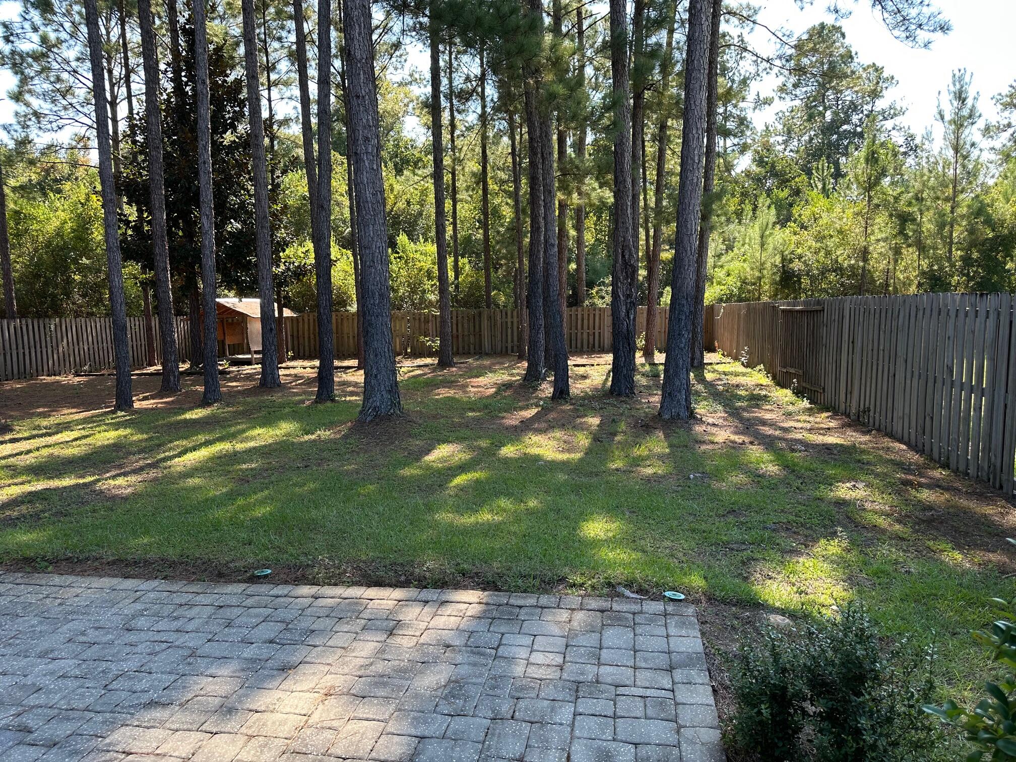 456 Windchime Way Freeport, FL 32439 - Photo 33 of 34 a backyard of a house with table and chairs