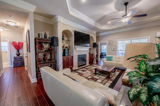 a living room with furniture a flat screen tv and a fireplace