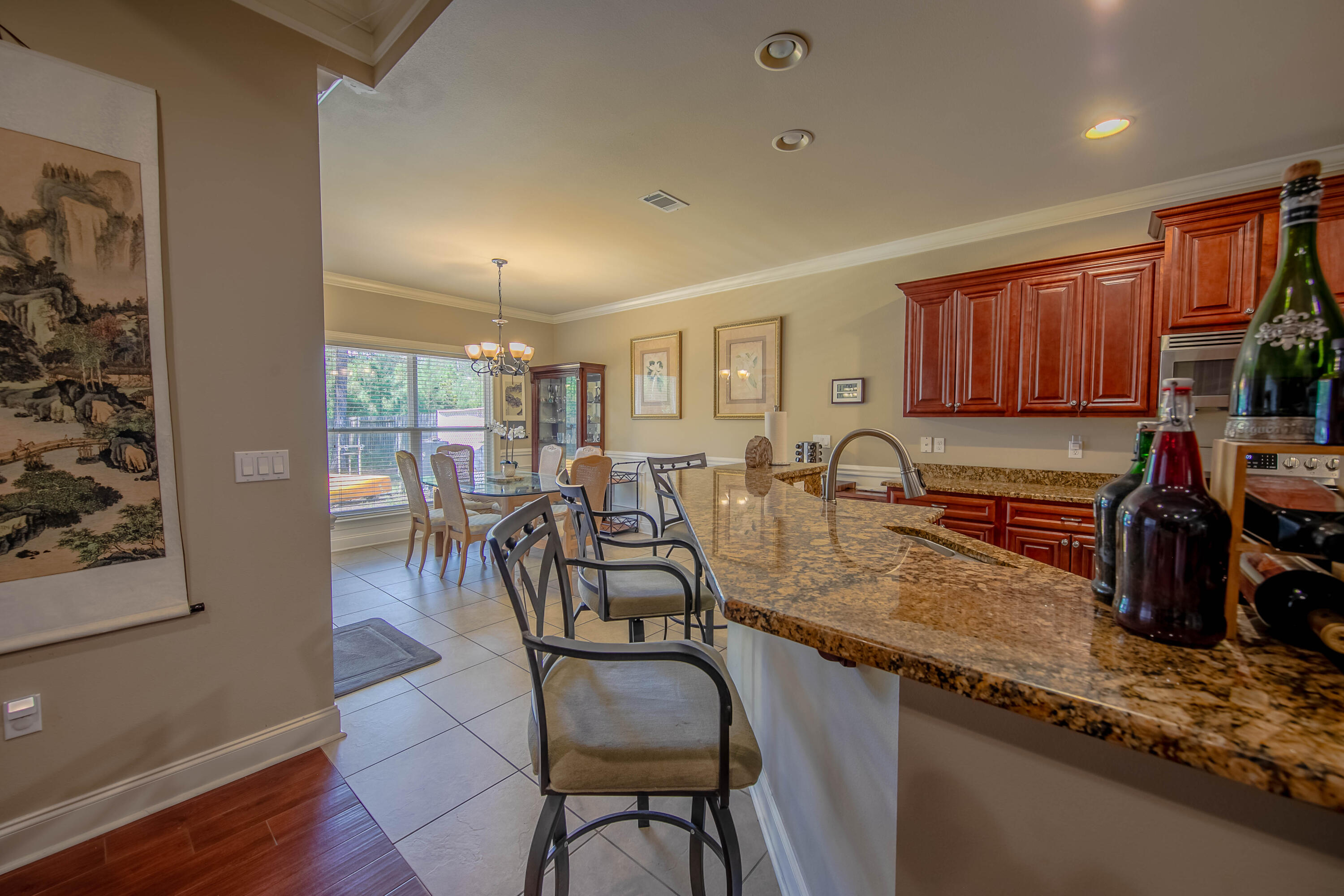 456 Windchime Way Freeport, FL 32439 - Photo 7 of 34 a kitchen with granite countertop a table chairs stove and sink