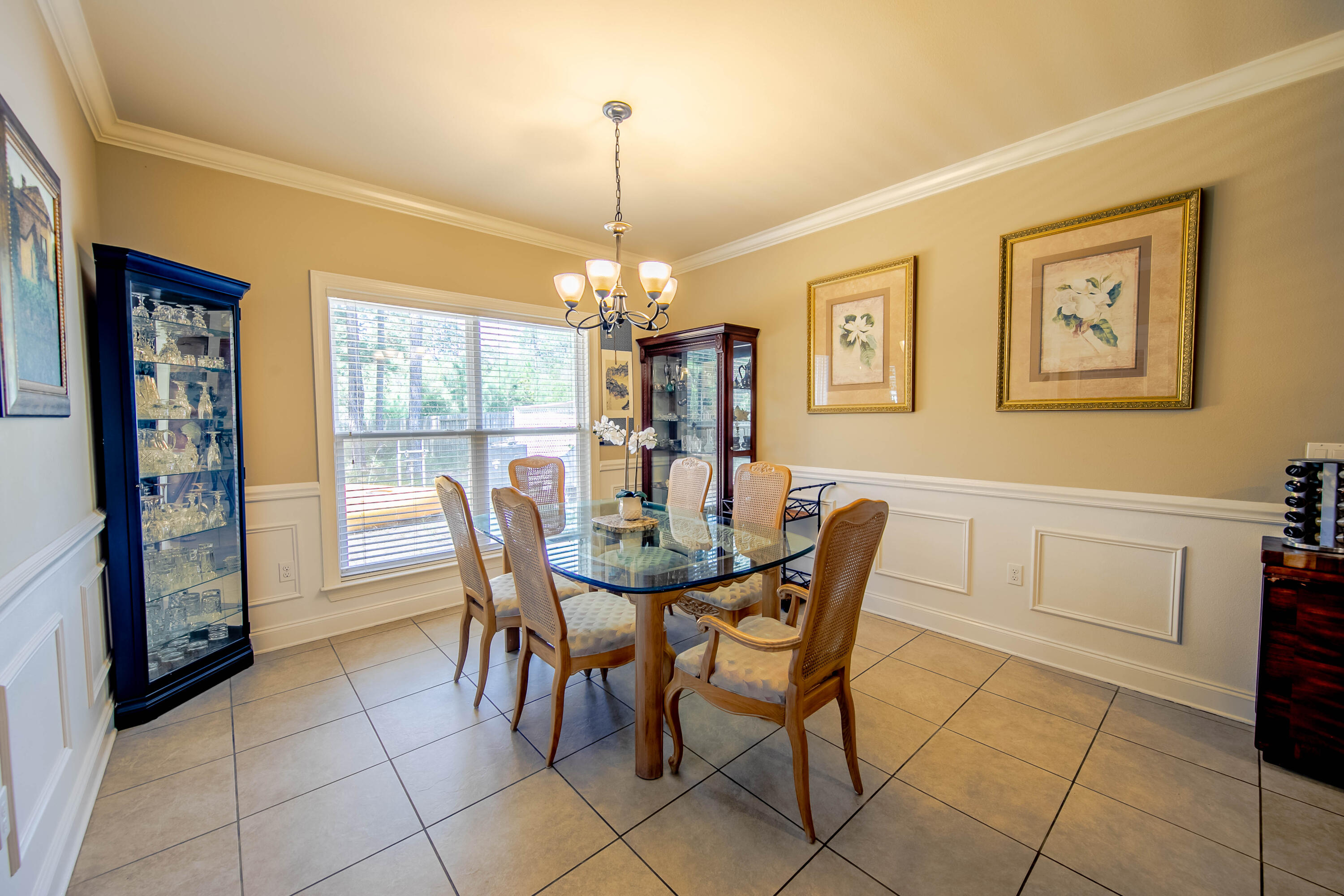 456 Windchime Way Freeport, FL 32439 - Photo 8 of 34 a dining room with furniture a chandelier and window
