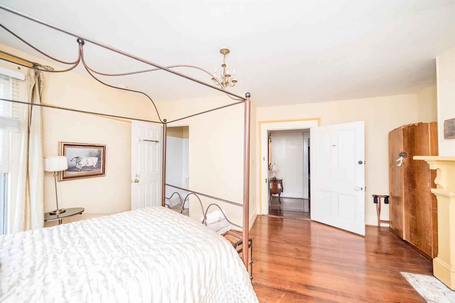 2416 Lowesville Road Amherst, VA 24521 - Photo 76 of 98 a bedroom with a bed and a chandelier