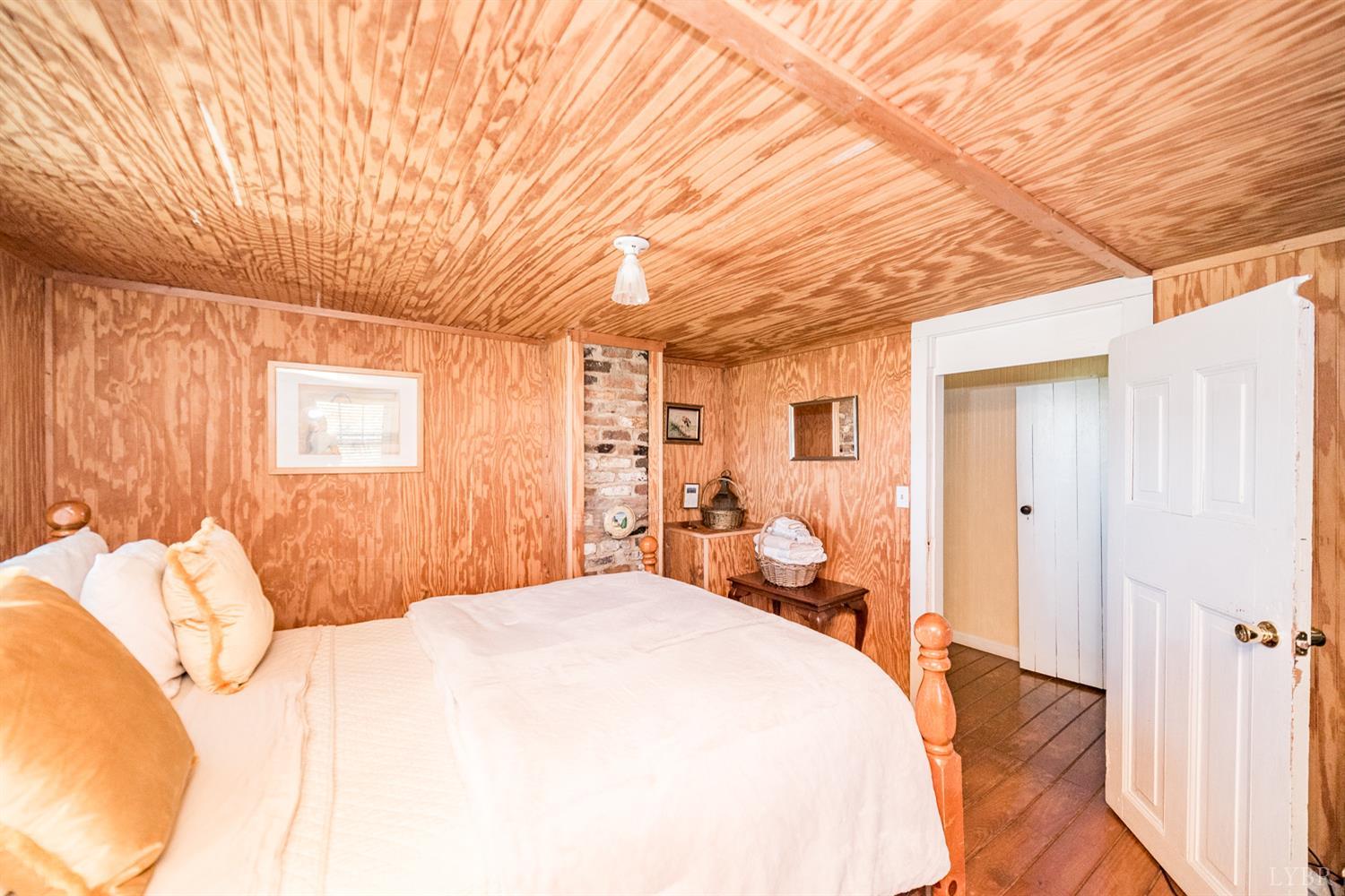 2416 Lowesville Road Amherst, VA 24521 - Photo 88 of 98 a spacious bedroom with a bed and a chandelier