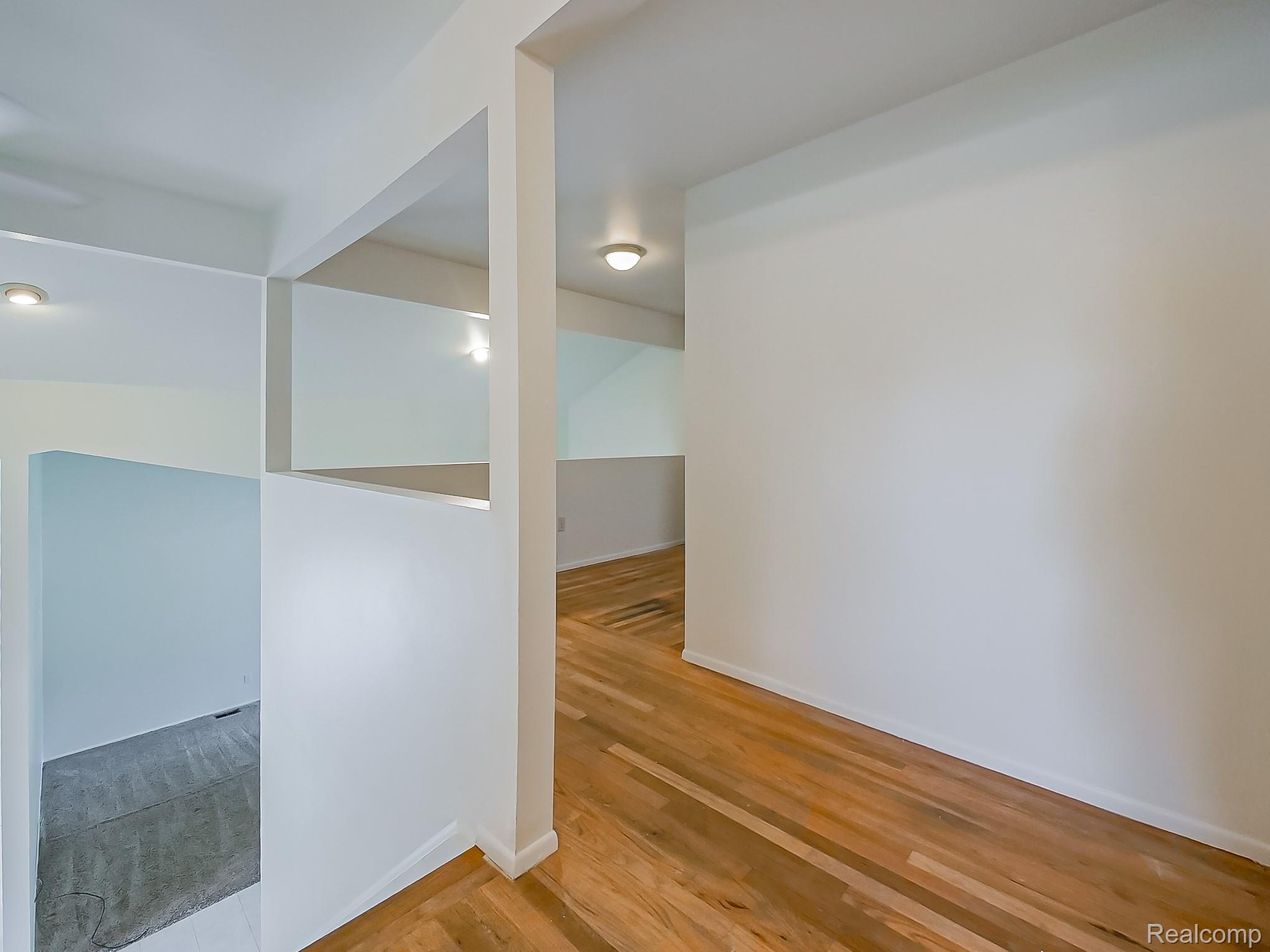 42195 Park Ridge Road Novi, MI 48375 - Photo 18 of 52 Light wood-finish flooring, white painted walls, recessed lighting, and a partial wall opening