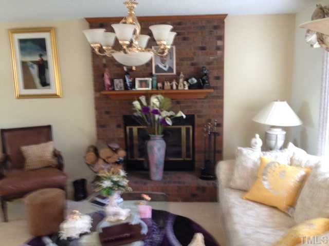 4220 Labrador Drive Raleigh, NC 27616 - Photo 4 of 15 a living room with furniture and a chandelier