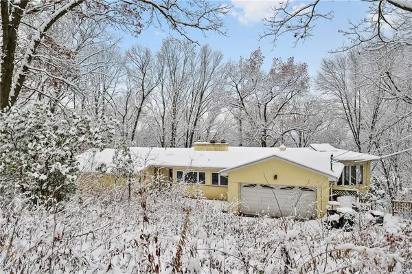 a view of a house with a yard and wooden fence