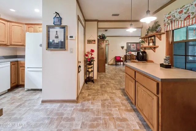 a kitchen with refrigerator and cabinets