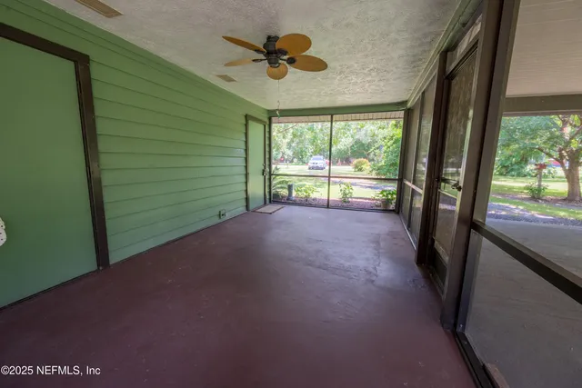 a view of room with window and a ceiling fan