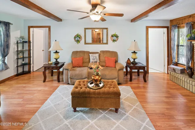 a living room with furniture and wooden floor