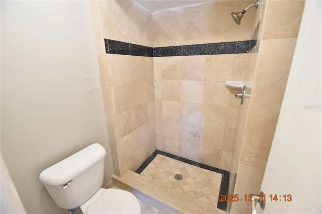 a bathroom with a toilet and a shower