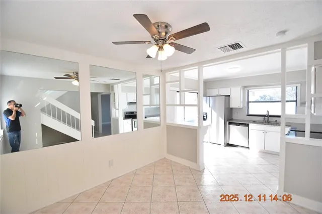 a living room with stainless steel appliances kitchen island granite countertop furniture and a view of kitchen