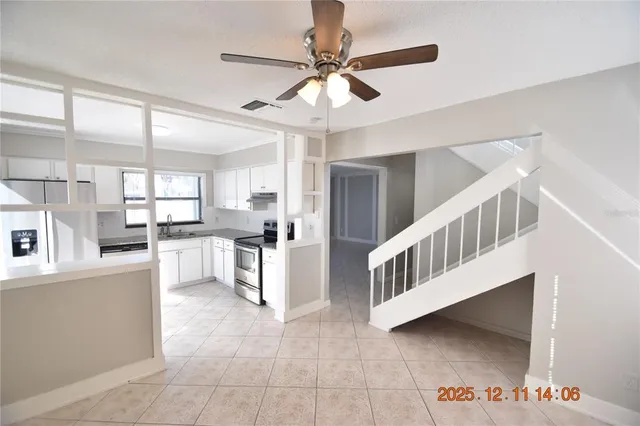 a view of kitchen with cabinets and window