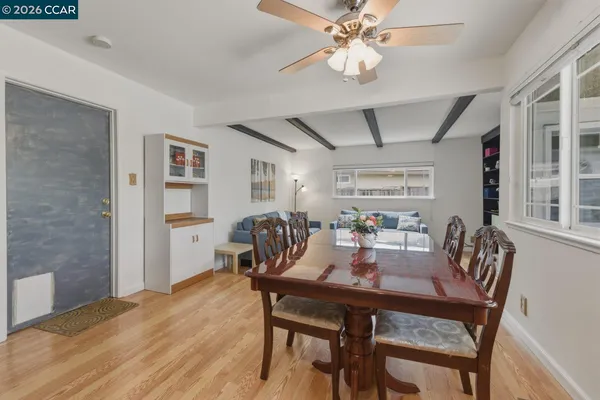 a view of a dining room with furniture and wooden floor