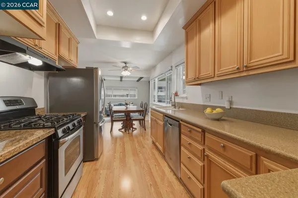 a kitchen with stainless steel appliances granite countertop a stove and a microwave