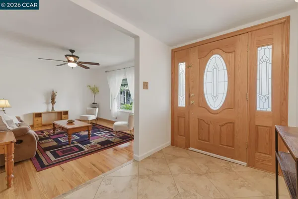 a living room with furniture a flat screen tv and a large window