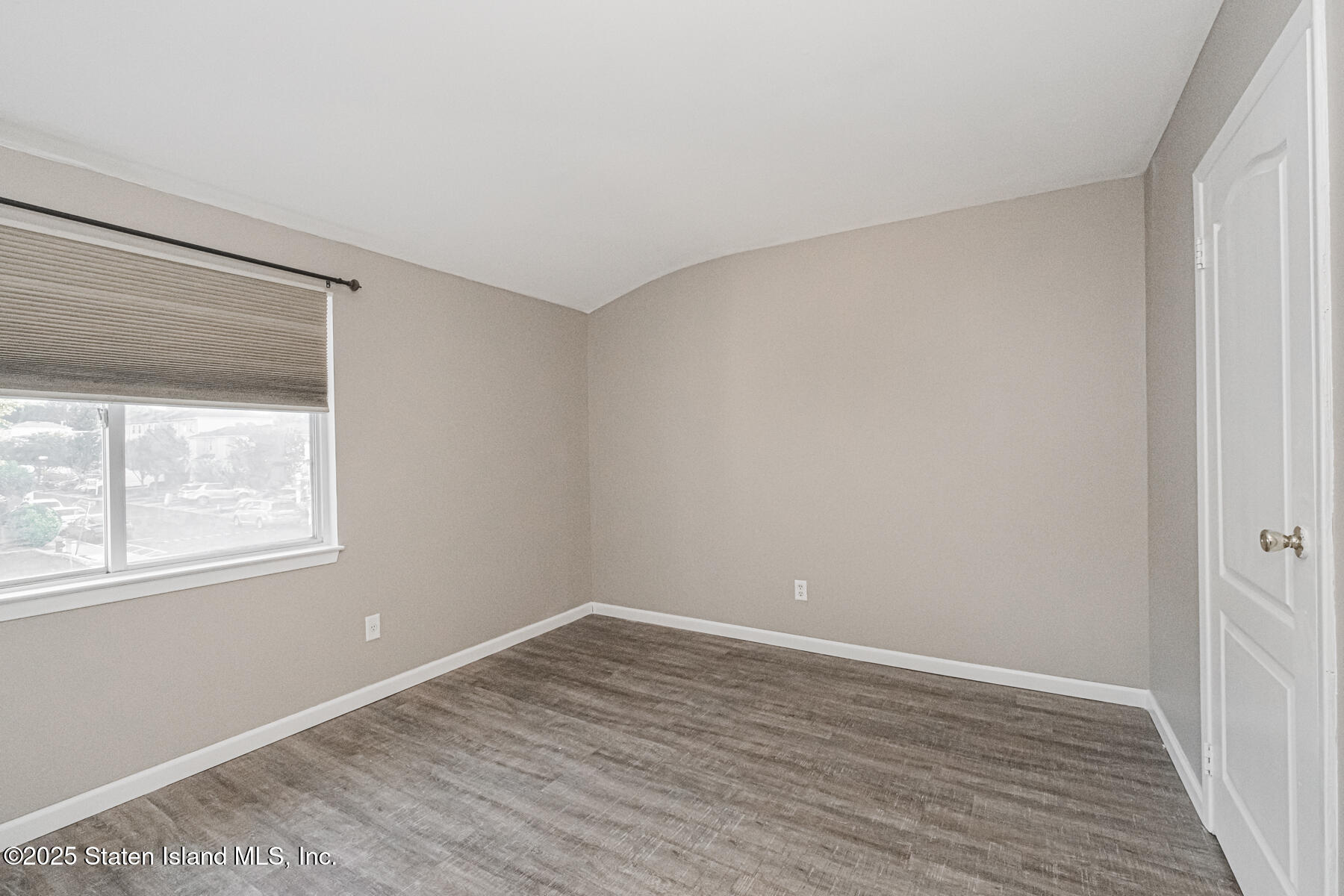 34 Lorraine Loop Staten Island, NY 10309 - Photo 12 of 33 an empty room with wooden floor and windows