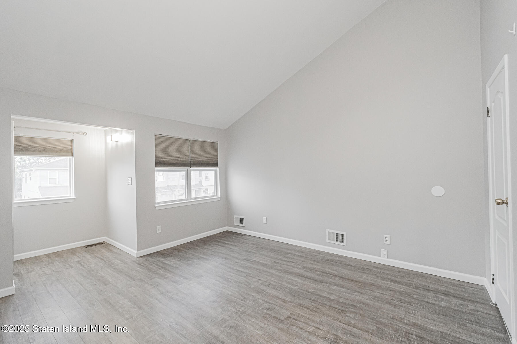 34 Lorraine Loop Staten Island, NY 10309 - Photo 14 of 33 a view of an empty room with wooden floor and a window