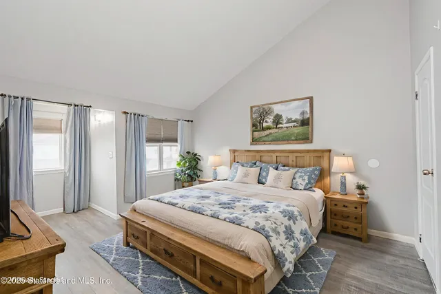 a bedroom with a large bed and a couch