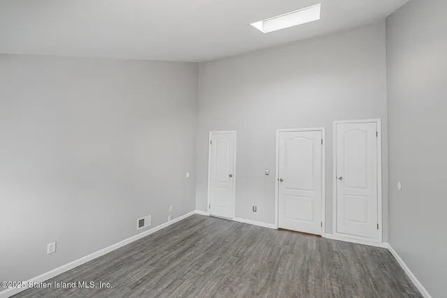 a view of an empty room and wooden floor