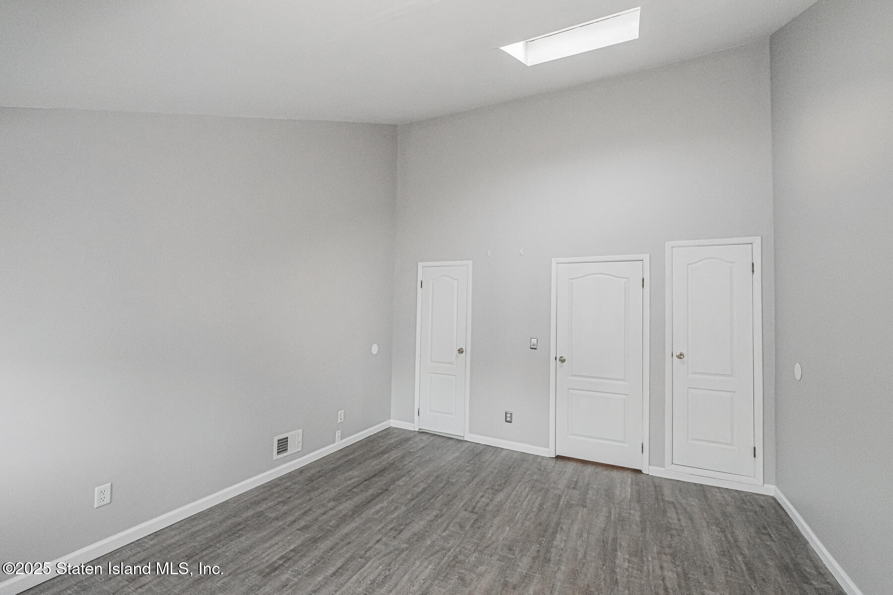 34 Lorraine Loop Staten Island, NY 10309 - Photo 17 of 33 a view of an empty room and wooden floor