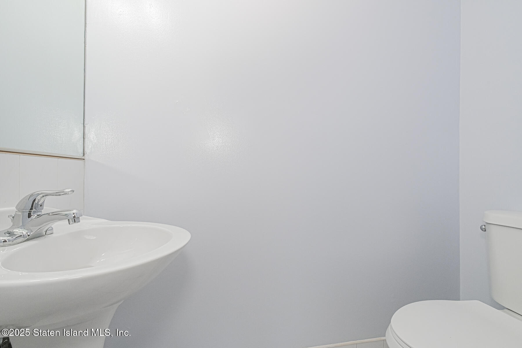 34 Lorraine Loop Staten Island, NY 10309 - Photo 21 of 33 a white toilet sitting next to a white sink