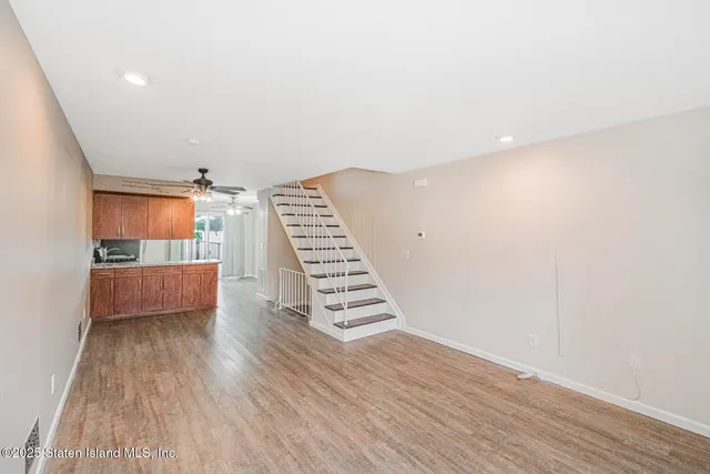 a view of wooden floor and windows in a room