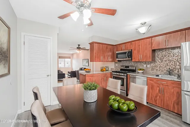 a kitchen with stainless steel appliances granite countertop a stove refrigerator and a microwave