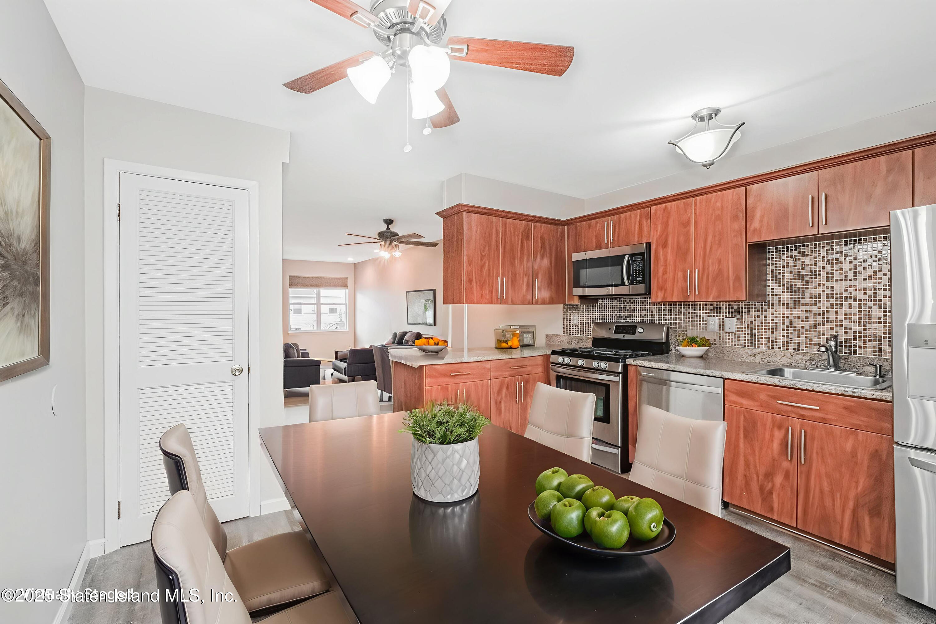 34 Lorraine Loop Staten Island, NY 10309 - Photo 9 of 33 a kitchen with stainless steel appliances granite countertop a stove refrigerator and a microwave
