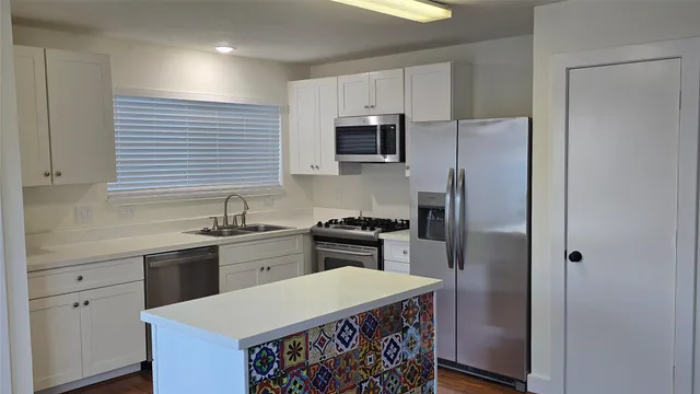 a kitchen with a sink stove and refrigerator