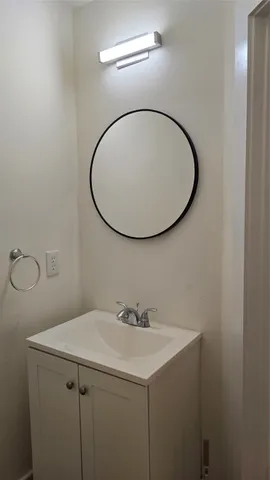 a bathroom with a sink and mirror