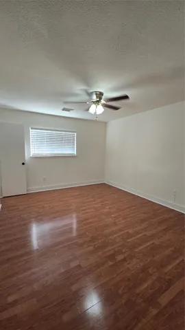 a view of a room with wooden floor
