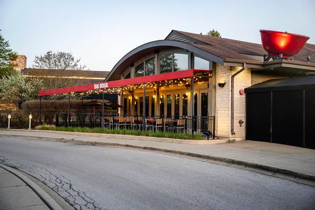 a view of a street with potted plants