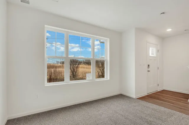 a view of an empty room and closet area