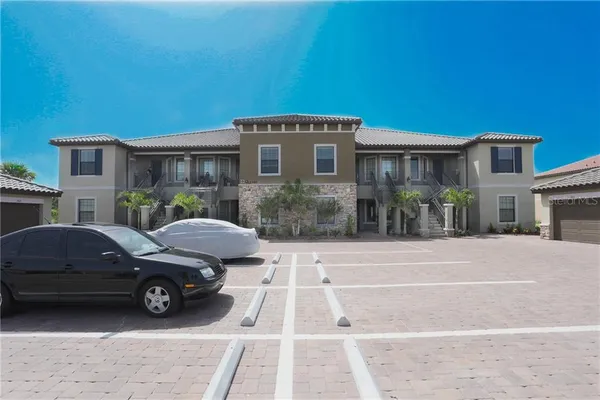 a view of a car parked in front of a brick house