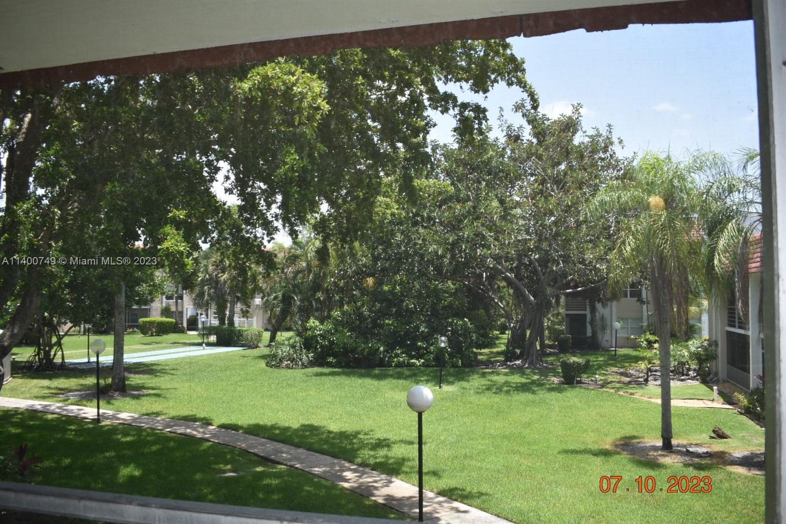 3501 Inverrary Drive, Unit 204 Lauderhill, FL 33319 - Photo 2 of 18 a backyard of a house with lots of green space
