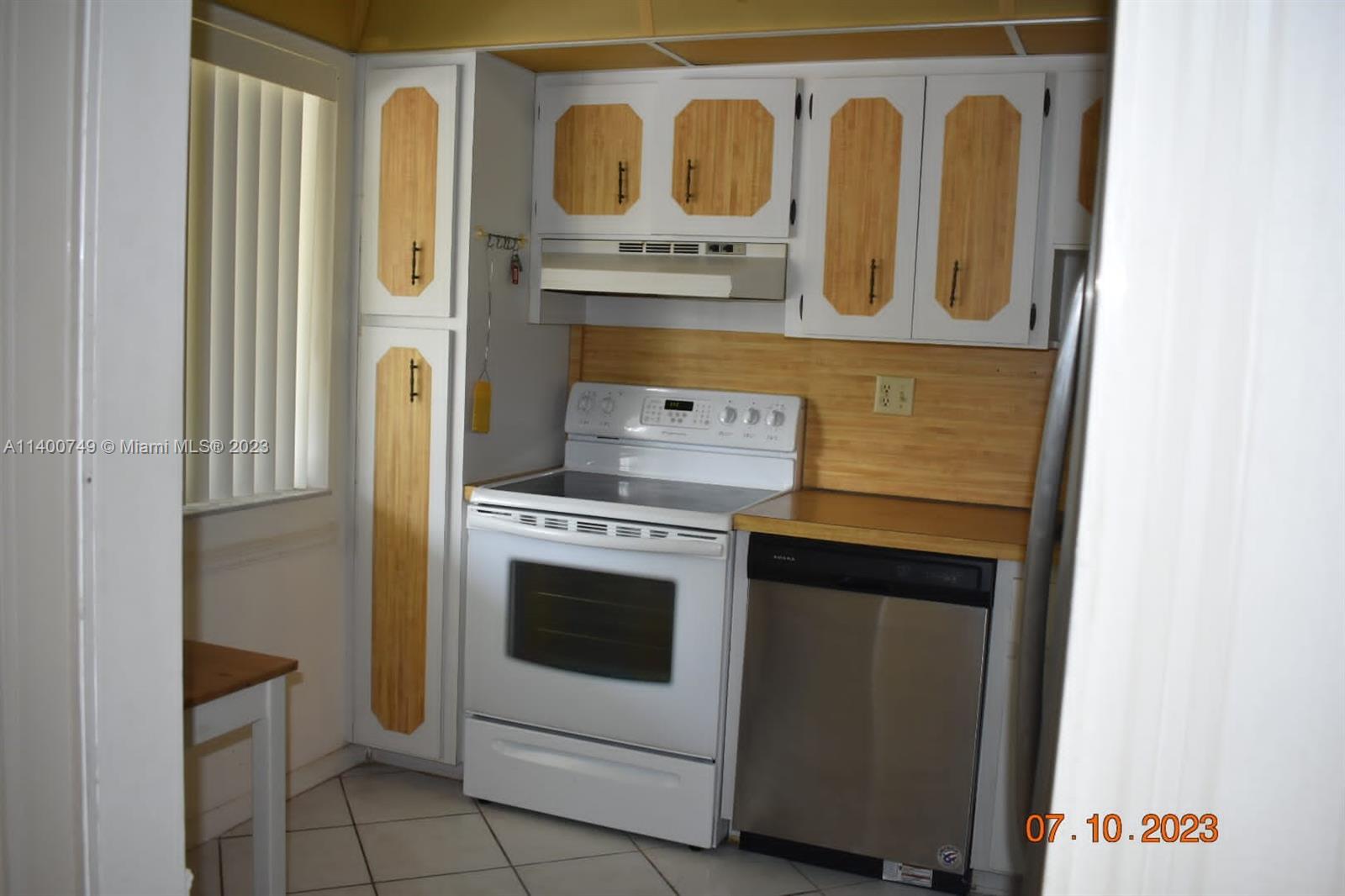 3501 Inverrary Drive, Unit 204 Lauderhill, FL 33319 - Photo 3 of 18 a kitchen with a stove and a microwave