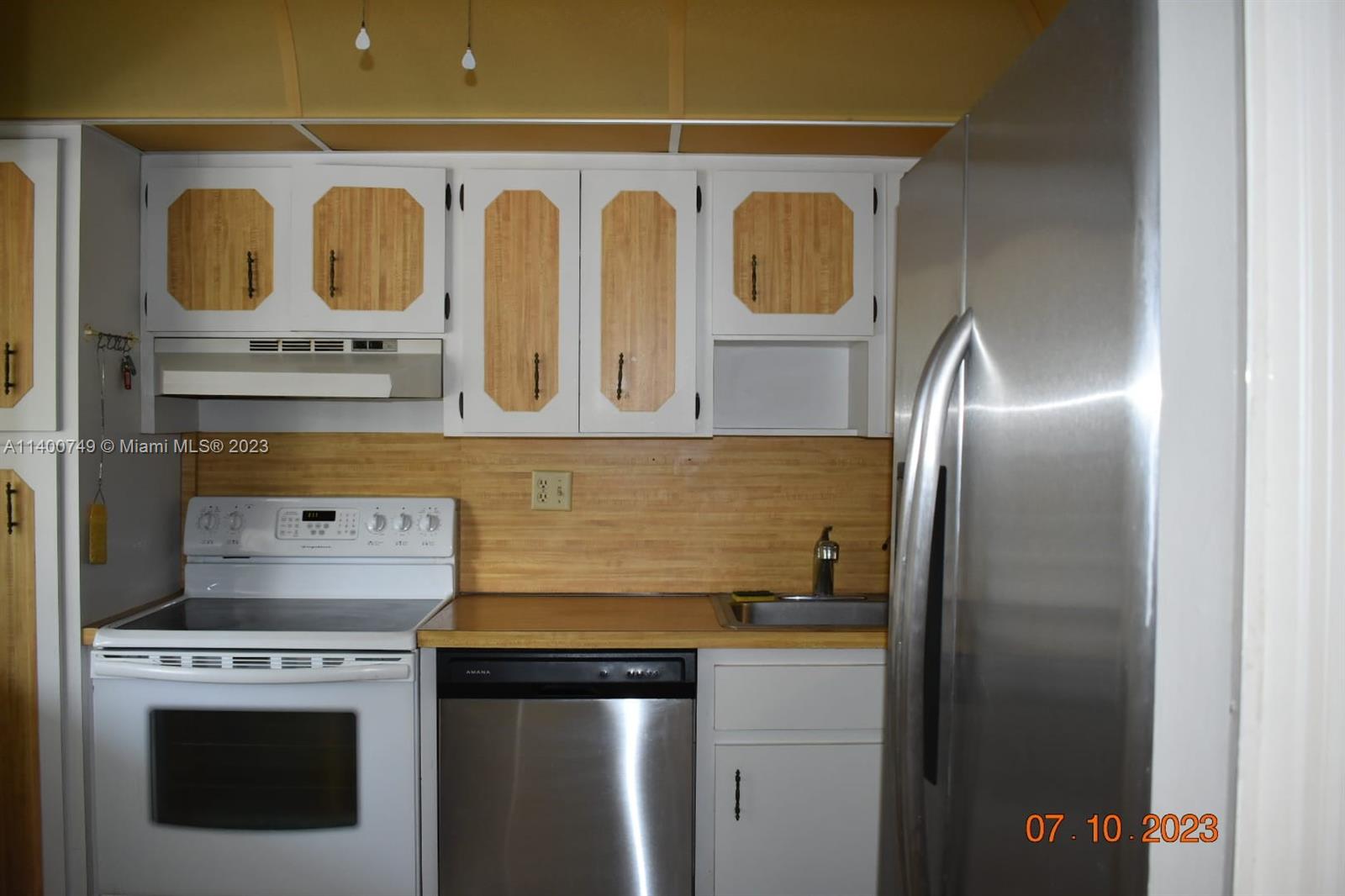 3501 Inverrary Drive, Unit 204 Lauderhill, FL 33319 - Photo 5 of 18 a kitchen with granite countertop a stove and a refrigerator