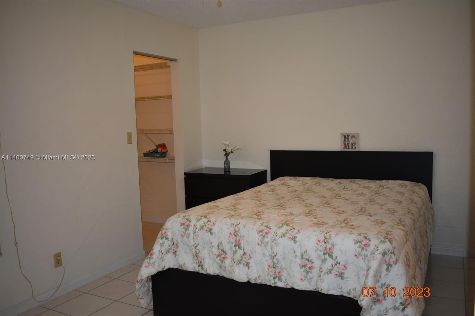 3501 Inverrary Drive, Unit 204 Lauderhill, FL 33319 - Photo 7 of 18 a bed sitting in a bedroom next to a window