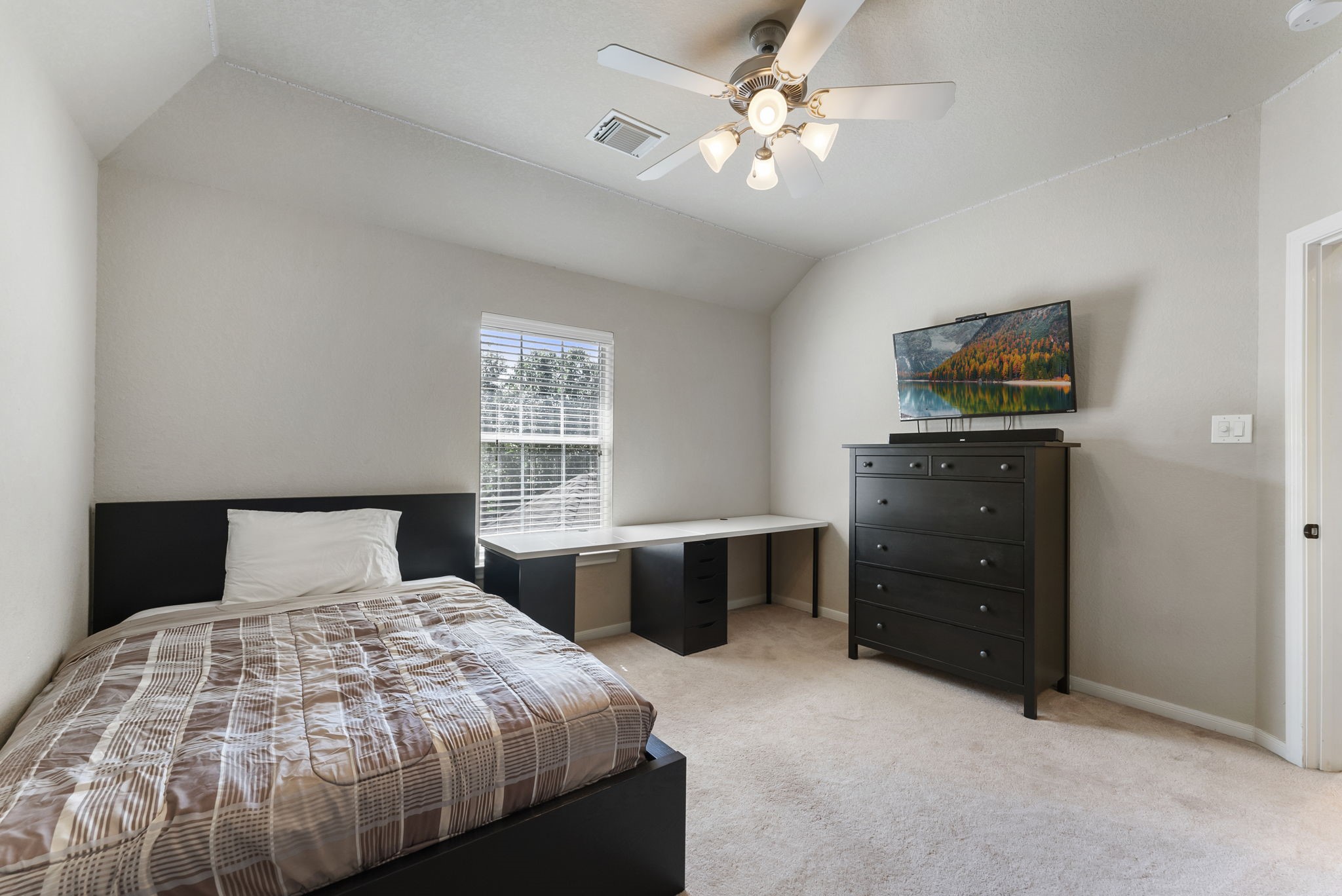 19223 Senterra Lakes Boulevard Spring, TX 77379 - Photo 30 of 48 a bedroom with a bed and a dresser