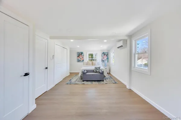a hallway with a couch and window